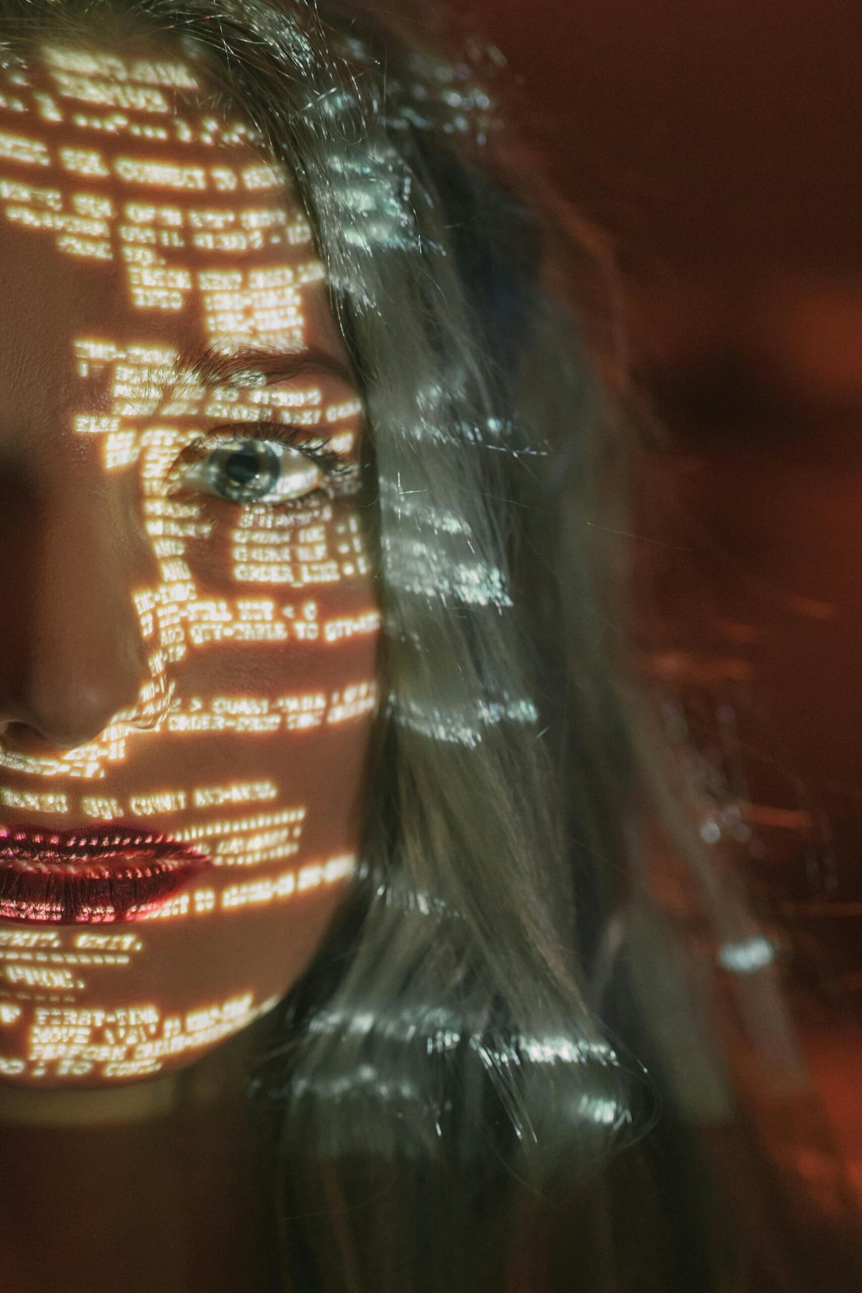 A futuristic image of artificial intelligence with computer code projected on a human face, symbolizing the rise of multimodal AI and AGI in 2025.