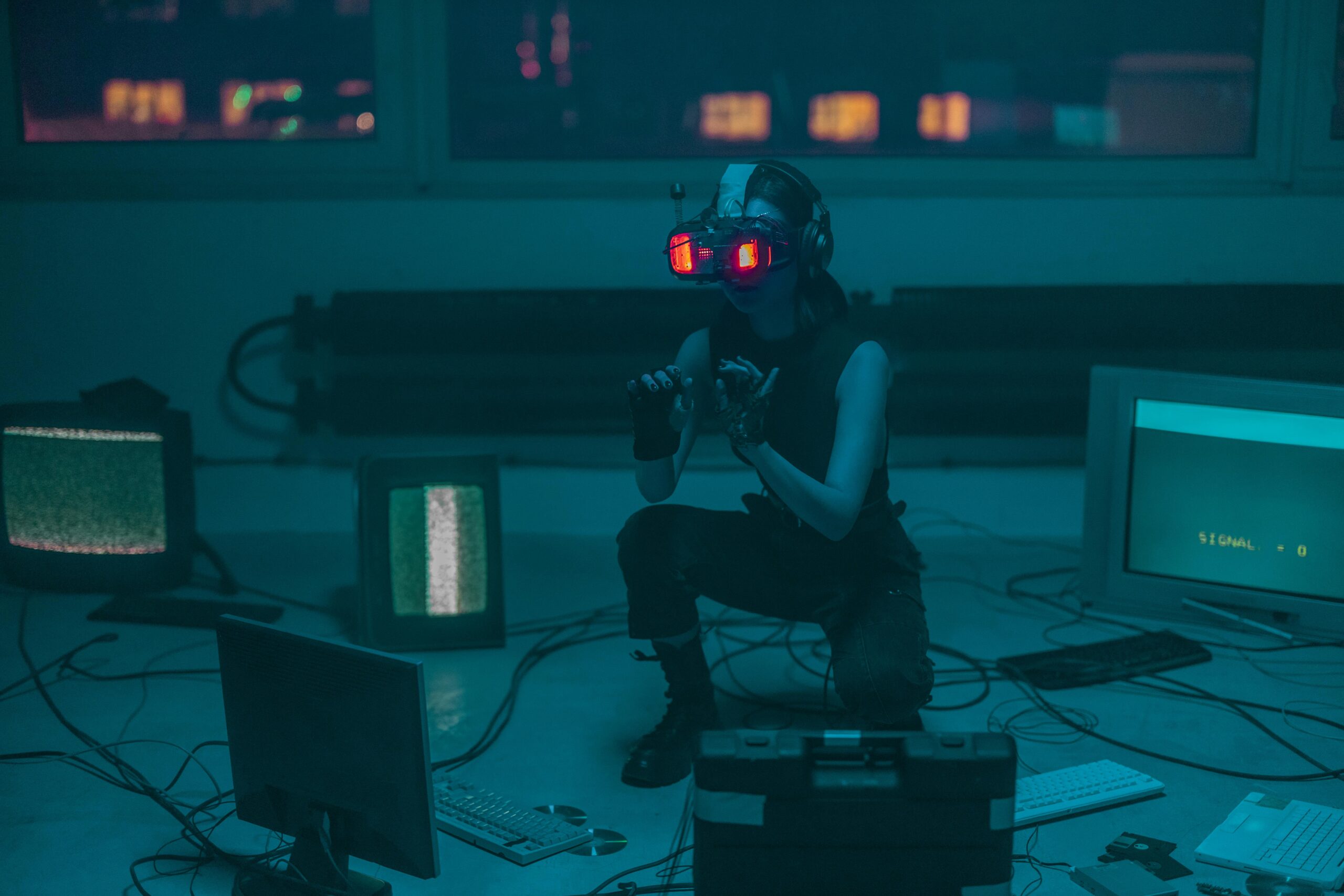 Futuristic cyberpunk hacker wearing augmented reality glasses, surrounded by old computer monitors and tangled wires in a dimly lit high-tech room.